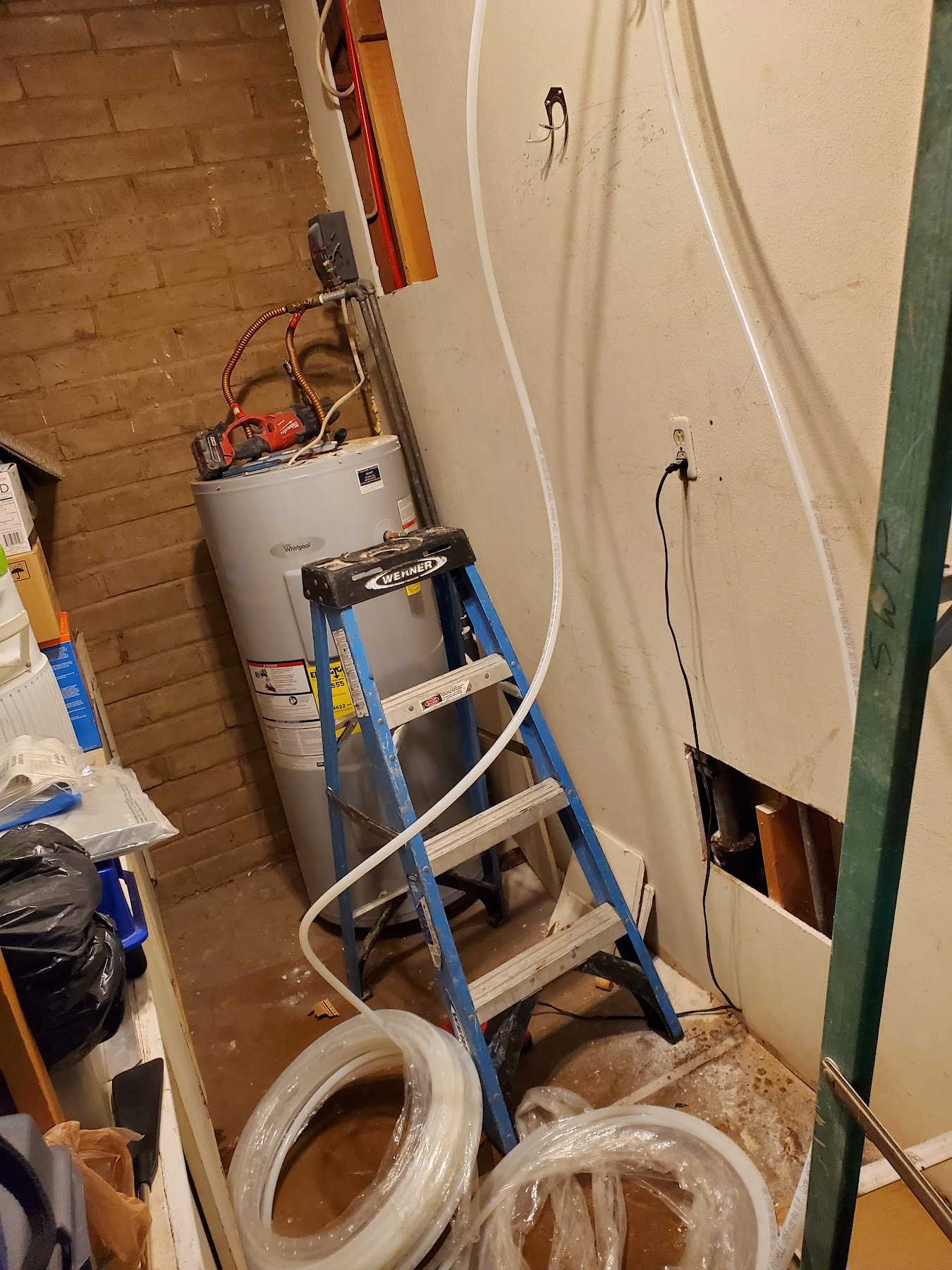 Whirlpool water heater service work with service ladder
